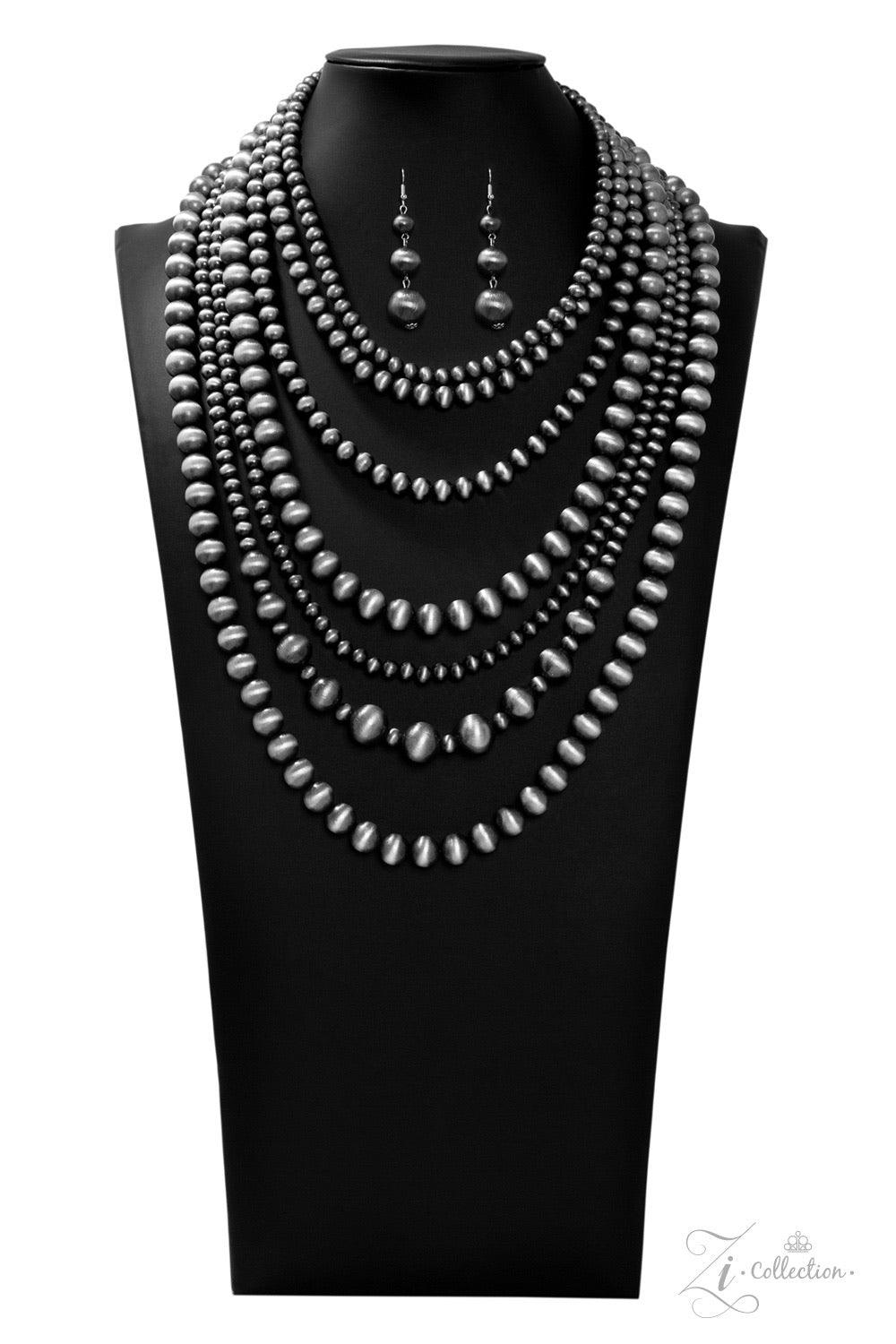 Paparazzi Accessories Instinct 💗ZiCollection $25💗 Strung between two silver fittings, row after row of hypnotizing gunmetal cat's eye beads cascade down the chest. The mesmerizing strands vary in size and pattern, creating haphazard layers of spellbindi