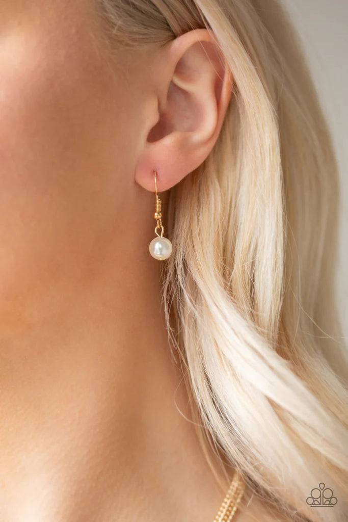 Paparazzi Accessories Regal Refinement - Gold Alternating with glassy white rhinestones, pearly white beaded tassels swing from the bottom of a shimmery gold chain below the collar for a refined flair. Features an adjustable clasp closure. Sold as one ind