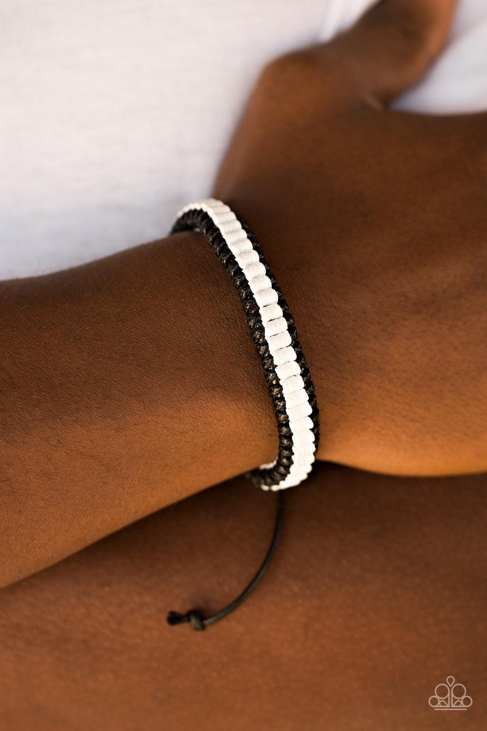 Paparazzi Accessories Trail Tracker - White Black and white cording weaves into a knotted braid around the wrist for an urban look. Features an adjustable sliding knot closure. Sold as one individual bracelet. Jewelry