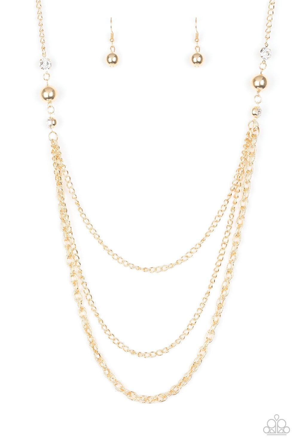 Paparazzi Accessories RITZ It All - Gold Glittery white rhinestones and oversized gold beads give way to layers of mismatched gold chains for a refined look. Features an adjustable clasp closure. Jewelry