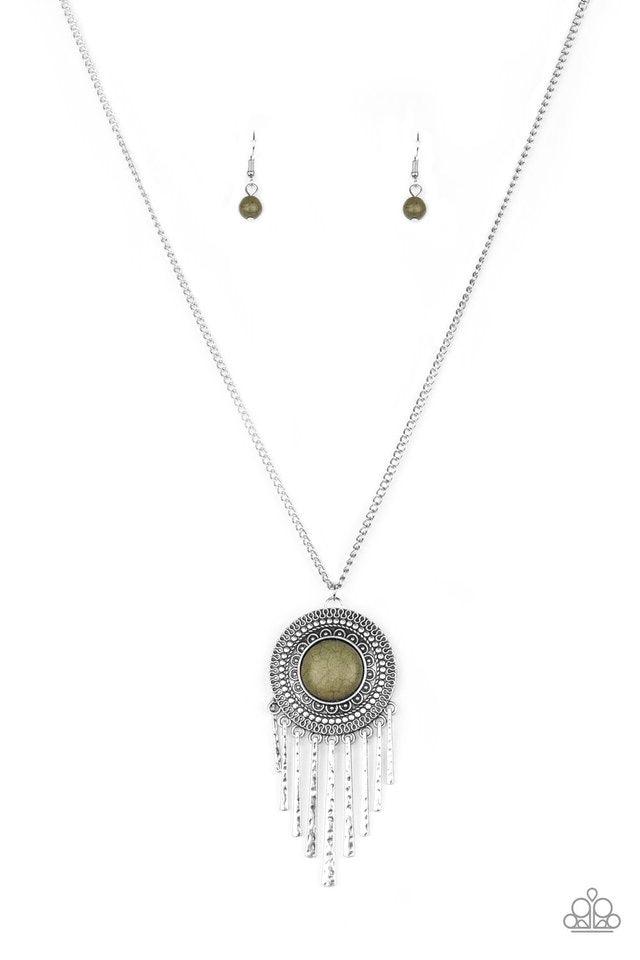 Paparazzi Accessories Bon Voyager - Green An earthy green stone is pressed into the center of a shimmery silver disc radiating with glistening tribal details. Swinging from the bottom of a lengthened silver chain, the bold pendant gives way to a fringe of