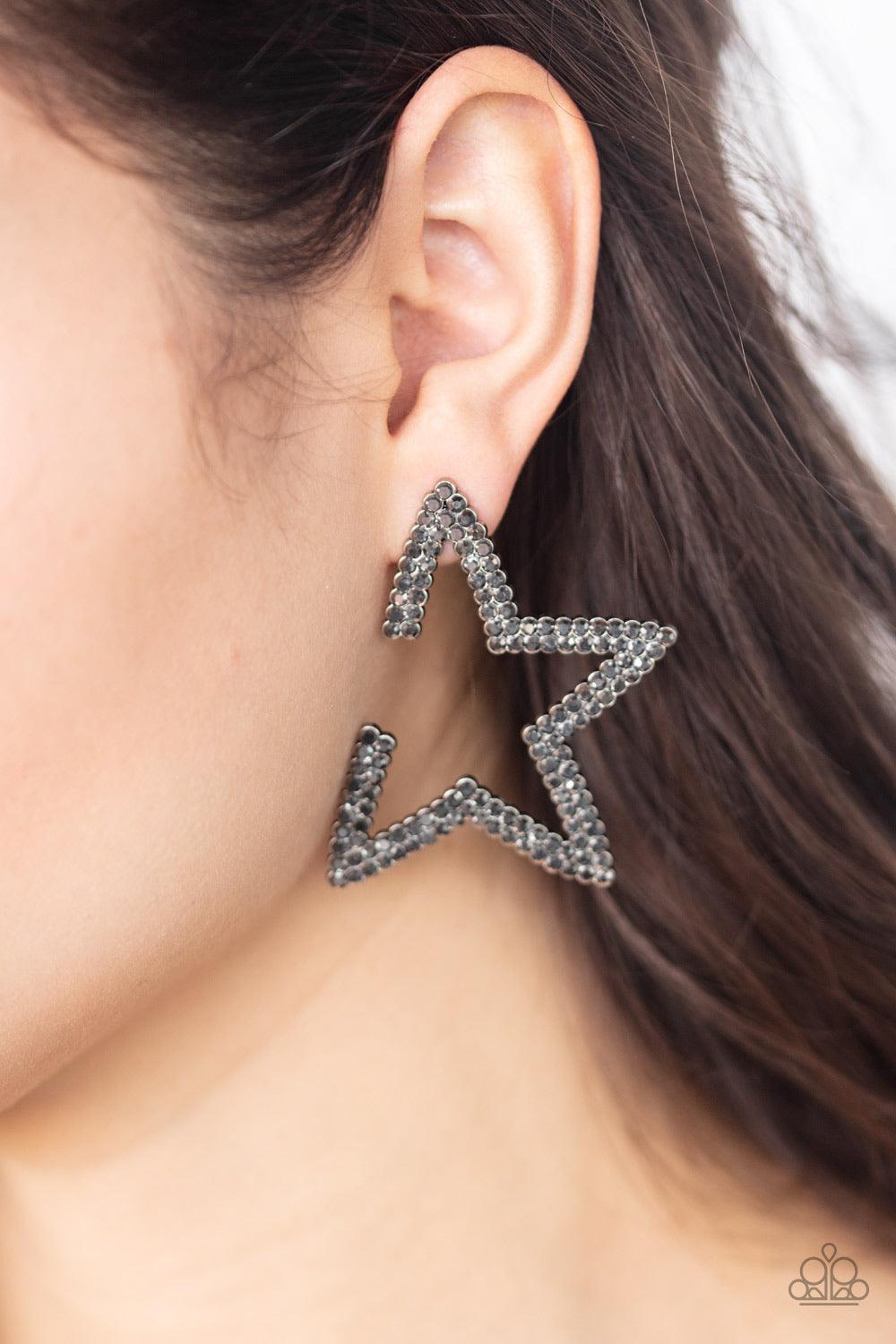 Paparazzi Accessories Star Player - Silver Encrusted in two rows of smoky hematite rhinestones, a gunmetal star frame dots the ear for a stellar shimmer. To flatter the natural contour of the face, one side angle of the star frame is intentionally left op