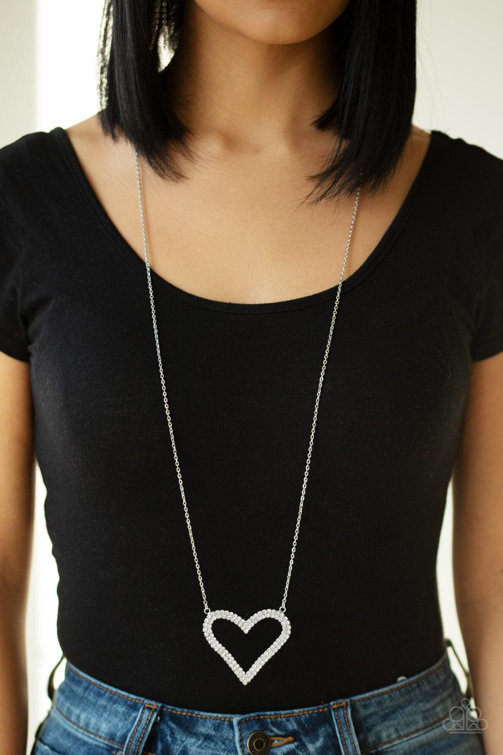 Paparazzi Accessories Pull Some HEART-strings - White Two rows of glittery white rhinestones stack into a sparkling heart pendant at the bottom of a lengthened silver chain for a heart-stopping look. Features an adjustable clasp closure. Jewelry