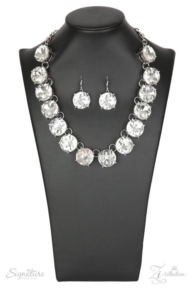 Paparazzi Accessories The Marissa Dramatically oversized rhinestones drip from the collar, bringing a modern twist to a classic concept. The quarter-sized rhinestones brilliantly catch and reflect the light, creating blinding sparkle that will leave a las