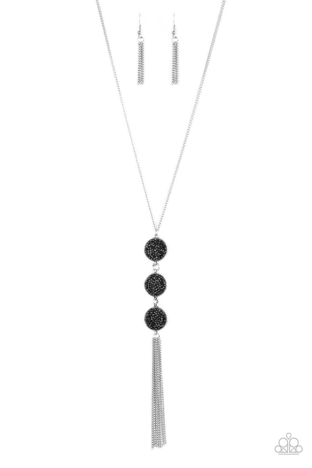 Paparazzi Accessories Triple Shimmer - Black Sprinkled in glittery black prism style rhinestones, three sparkling silver frames trickle down the chest. A shimmery silver tassel swings from the bottom of the triple stacked pendant for a glamorous finish. F