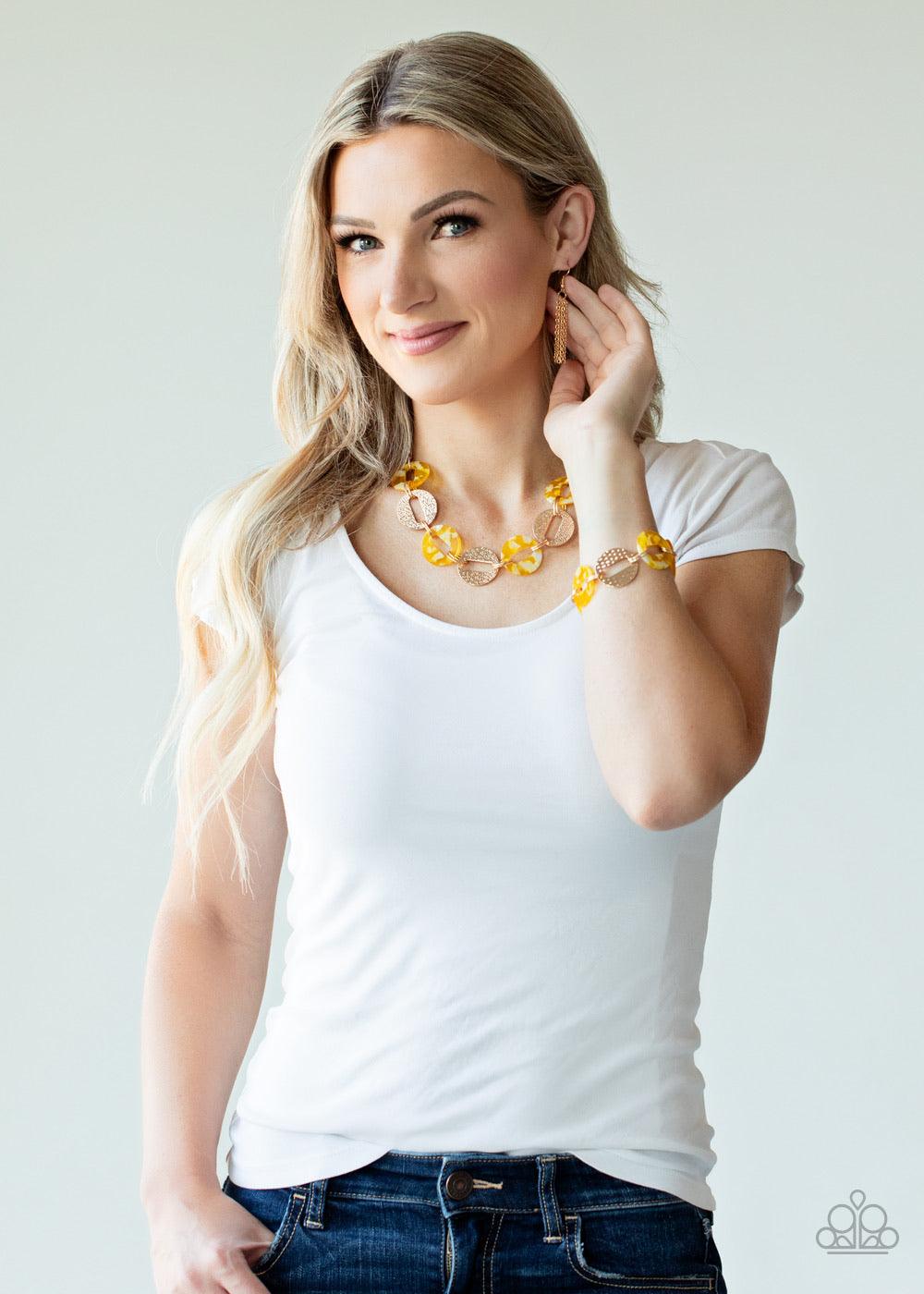 Paparazzi Accessories Retro Retrograde - Yellow Featuring airy circular shapes, hammered gold frames link with shiny yellow acrylic frames below the collar for a colorfully retro look. Features an adjustable clasp closure. Sold as one individual necklace.