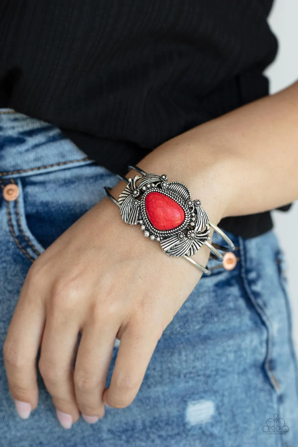 Paparazzi Accessories Western Wonderland - Red An asymmetrical red stone is pressed into the center of a rustic silver centerpiece stacked with flared silver frames, shiny studs, and antiqued floral accents. The whimsical frames sit atop a layered cuff, c