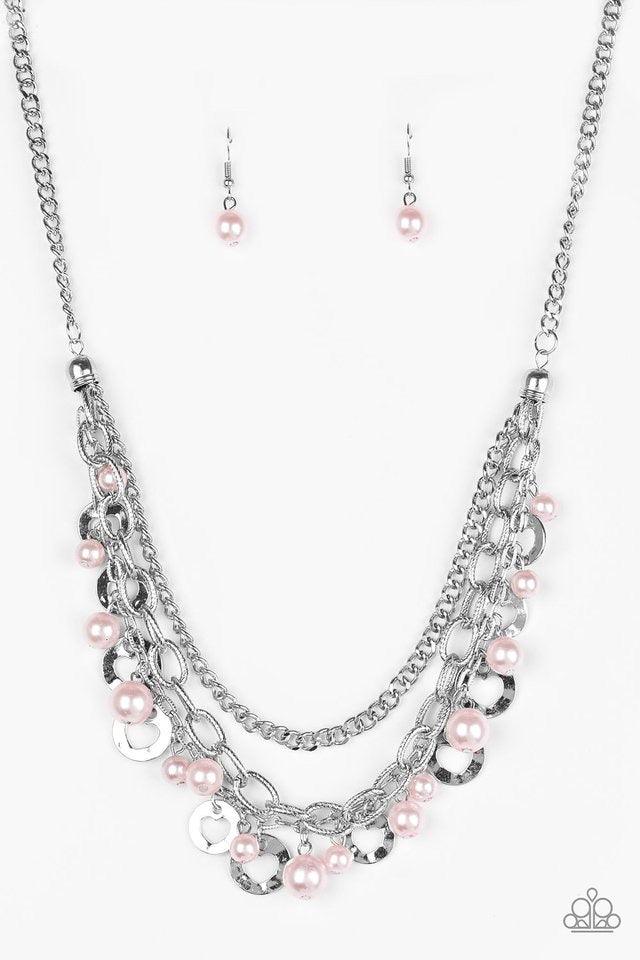 Paparazzi Accessories Hoppin Hearts - Pink Three rows of mismatched silver chains layer below the collar. Infused with airy heart cut-out centers, delicately hammered silver discs and pearly pink beads swing from the bottom of the lowermost chain, creatin