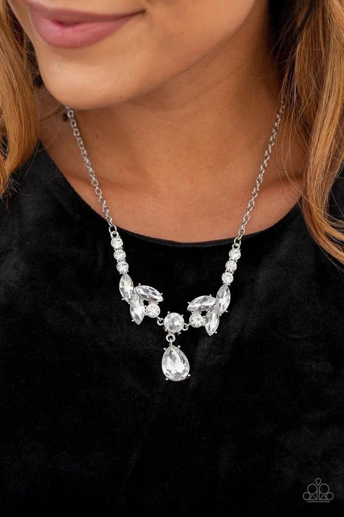 Paparazzi Accessories Unrivaled Sparkle - White Tiers of white rhinestone encrusted frames delicately link below the collar, giving way to an oversized white teardrop rhinestone pendant for a timeless finish. Features an adjustable clasp closure. Sold as