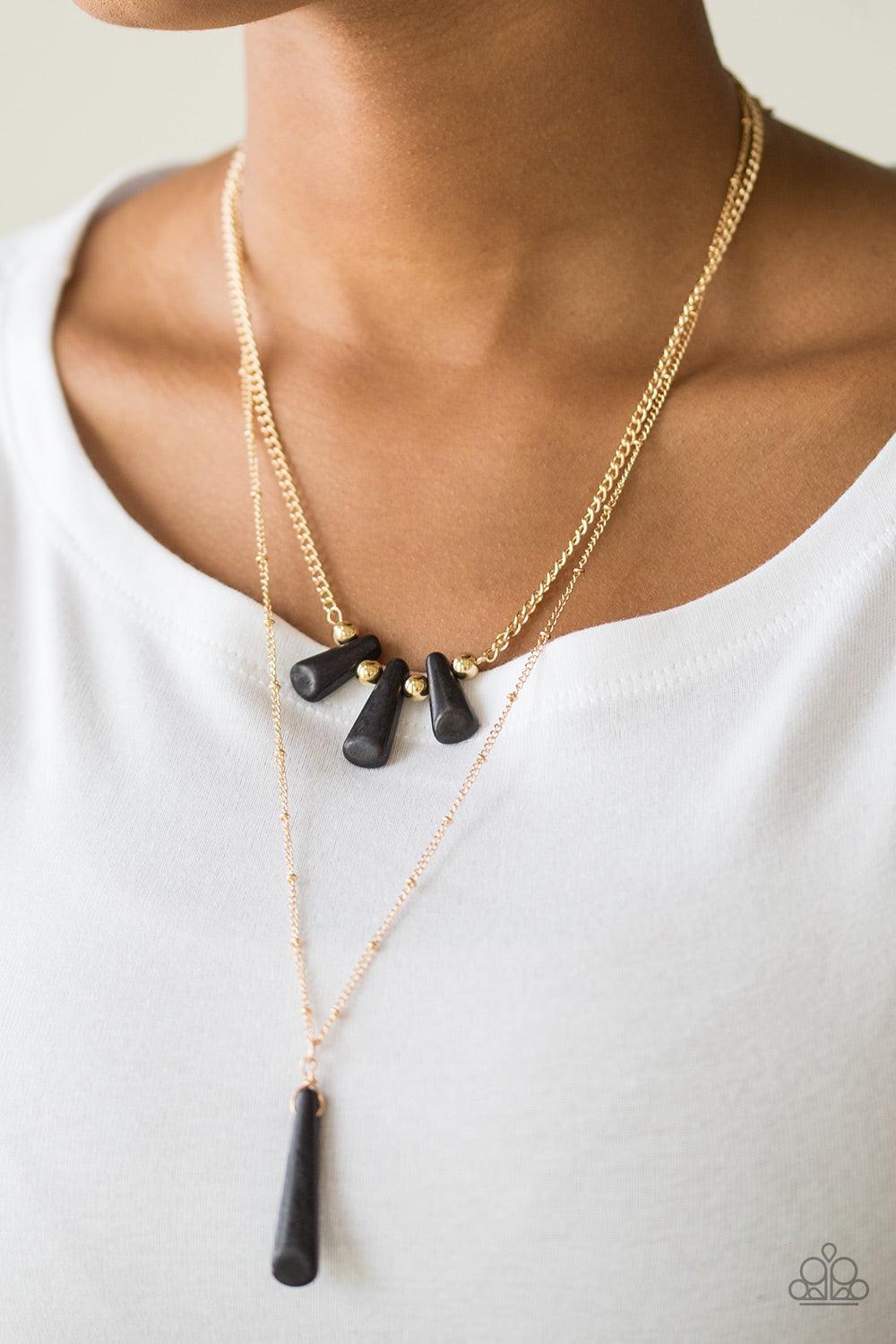 Paparazzi Accessories Basic Groundwork - Black Chiseled into flared teardrop shapes, a dainty fringe of black stones and golden beads gives way to a large stone pendant, creating earthy layers down the chest. Features an adjustable clasp closure. Jewelry
