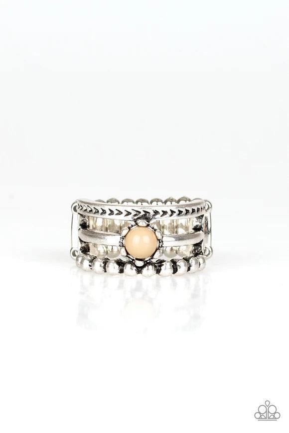 Paparazzi Accessories Pop Rival - Brown A trio of studded, smooth, and tribal stamped silver bands layer across the finger, coalescing into an airy frame. A dainty Soybean bead is pressed into the center of the shimmery layers for a perfect pop of color.