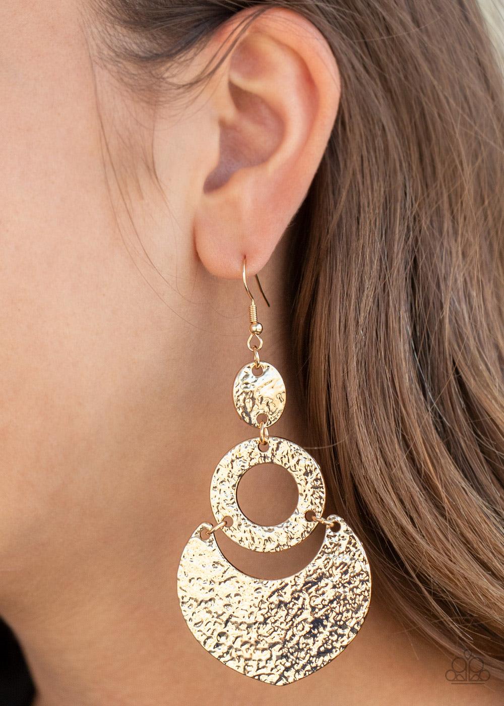 Paparazzi Accessories Shimmer Suite ~Gold Hammered and embossed in shimmery textures, oval, hoop, and crescent gold frames link into a blinding lure. Earring attaches to a standard fishhook fitting. Sold as one pair of earrings.