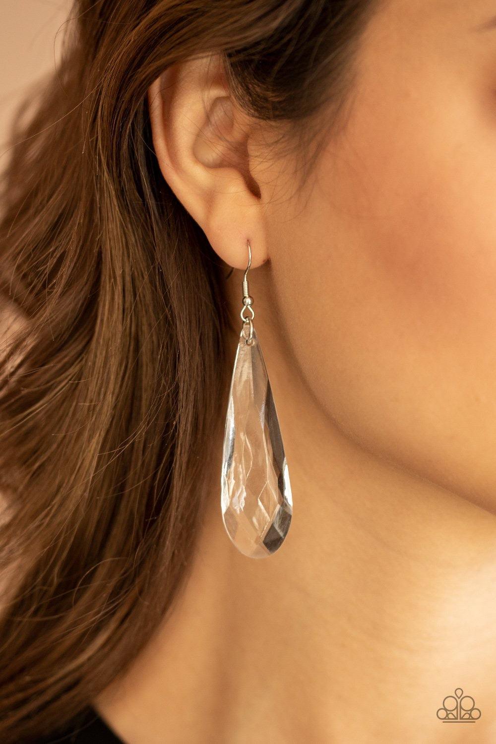 Paparazzi Accessories Crystal Crown - White A dramatically oversized white teardrop crystal swings from the ear, creating an irresistible statement piece. Earring attaches to a standard fishhook fitting. Jewelry