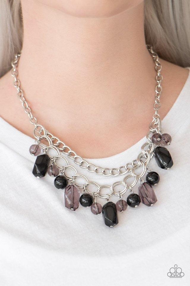 Paparazzi Accessories Brazilian Bay - Black Featuring glassy and polished finishes, round and asymmetrical black beads trickle from the bottom of a double-linked silver chain. An additional silver chain is layered above the summery beading for a seasonal