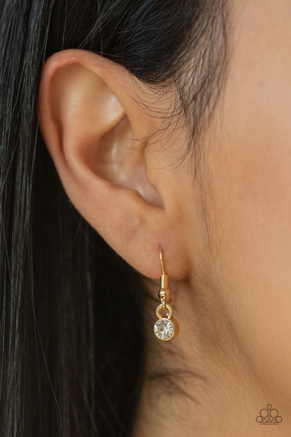 Paparazzi Accessories HEIRS and Graces - Gold Featuring round, marquise, and teardrop style cuts, a glassy collection of glittery white rhinestones coalesce into a blinding gold pendant below the collar. Features an adjustable clasp closure. Jewelry