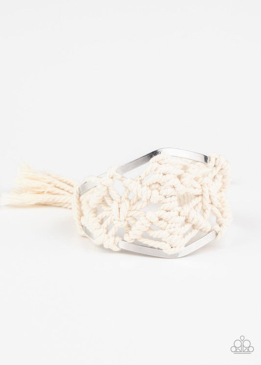 Paparazzi Accessories Macrame Mode - White White cording decoratively knots and weaves around an airy silver cuff for a macramé inspired look. Knotted around the ends, white tassels flair out from bottoms of the cuff for a wanderlust finish.Sold as one in