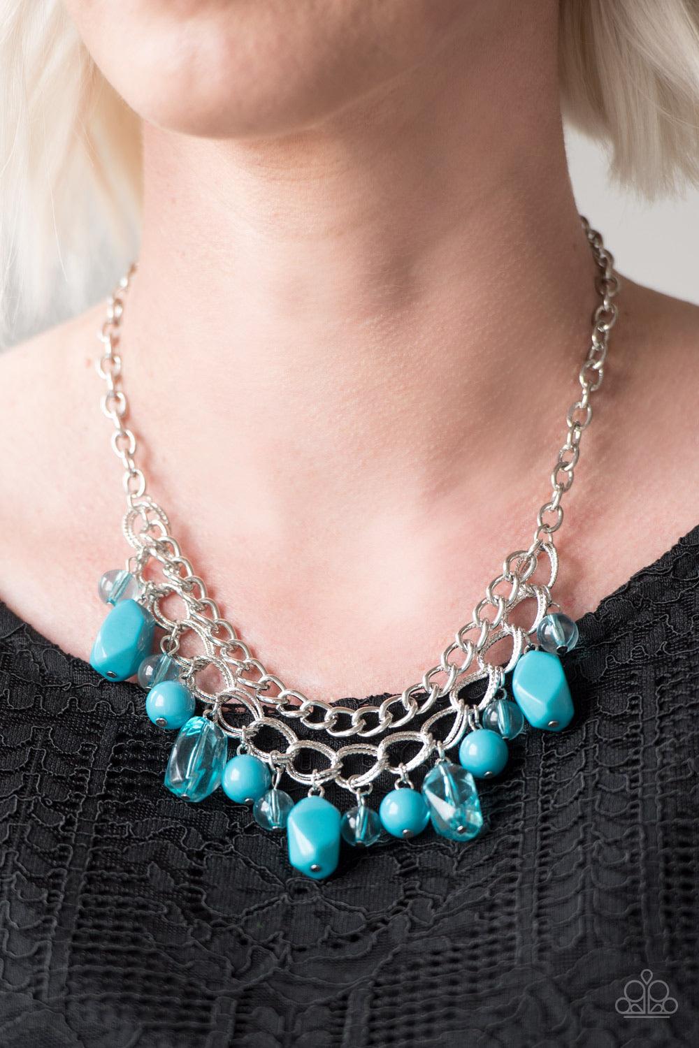 Paparazzi Accessories Brazilian Bay - Blue Featuring glassy and polished finishes, round and asymmetrical blue beads trickle from the bottom of a double-linked silver chain. An additional silver chain is layered above the summery beading for a seasonal fi