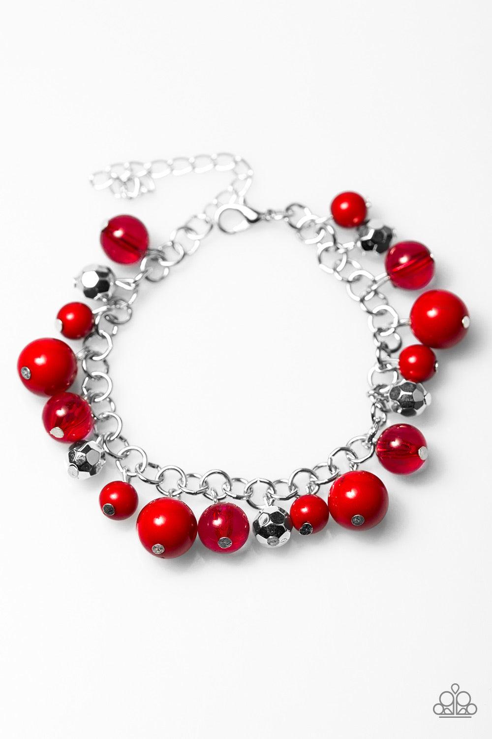 Paparazzi Accessories WANDERLUST For Life ~Red Polished and opaque red beading trickle from a shimmery silver chain, creating a colorful fringe around the wrist. Faceted silver beads are sprinkled between the colorful accents for a whimsical finish. Featu