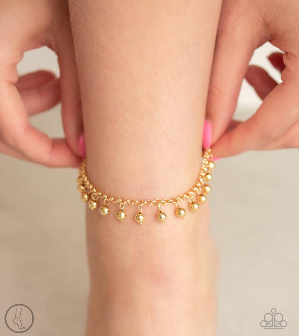 Paparazzi Accessories West Coast Cruzin - Gold *Anklet Dainty gold beads dangle from a shimmery gold chain encircling the ankle, creating a flirtatious fringe. Features an adjustable clasp closure. Jewelry