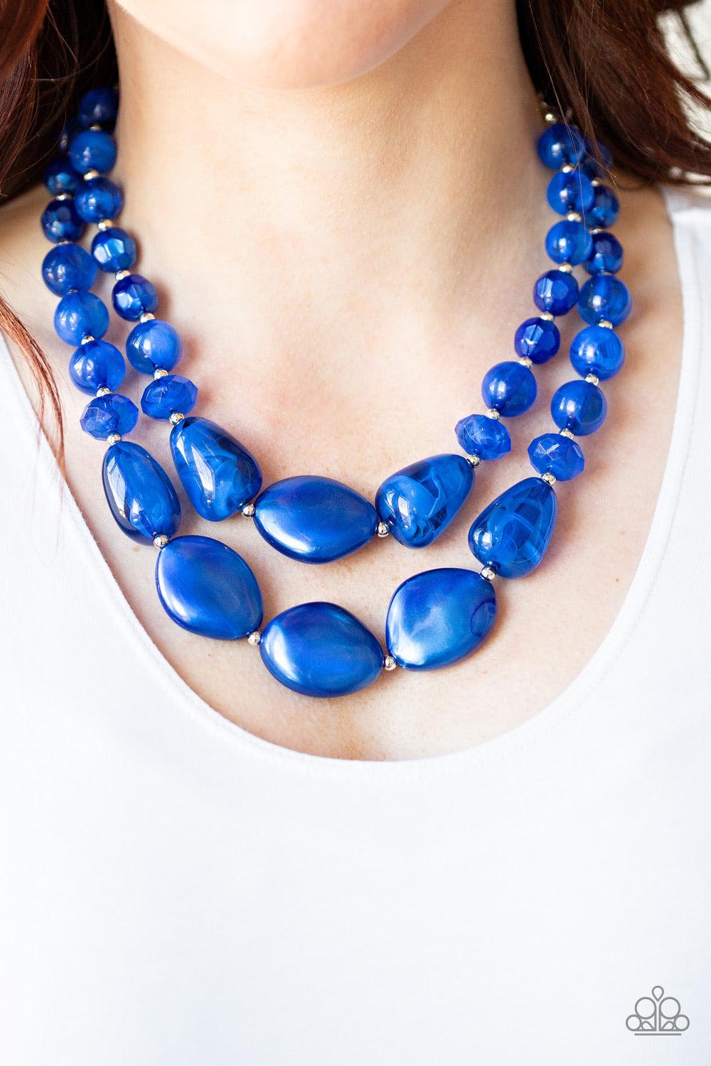 Paparazzi Accessories Beach Glam - Blue Varying in shape and opacity, a refreshing collection of glassy and iridescent Galaxy Blue beads layer below the collar for a boldly colorful look. Features an adjustable clasp closure. Sold as one individual neckla