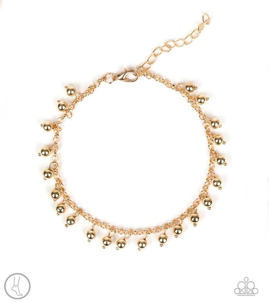 Paparazzi Accessories West Coast Cruzin - Gold *Anklet Dainty gold beads dangle from a shimmery gold chain encircling the ankle, creating a flirtatious fringe. Features an adjustable clasp closure. Jewelry