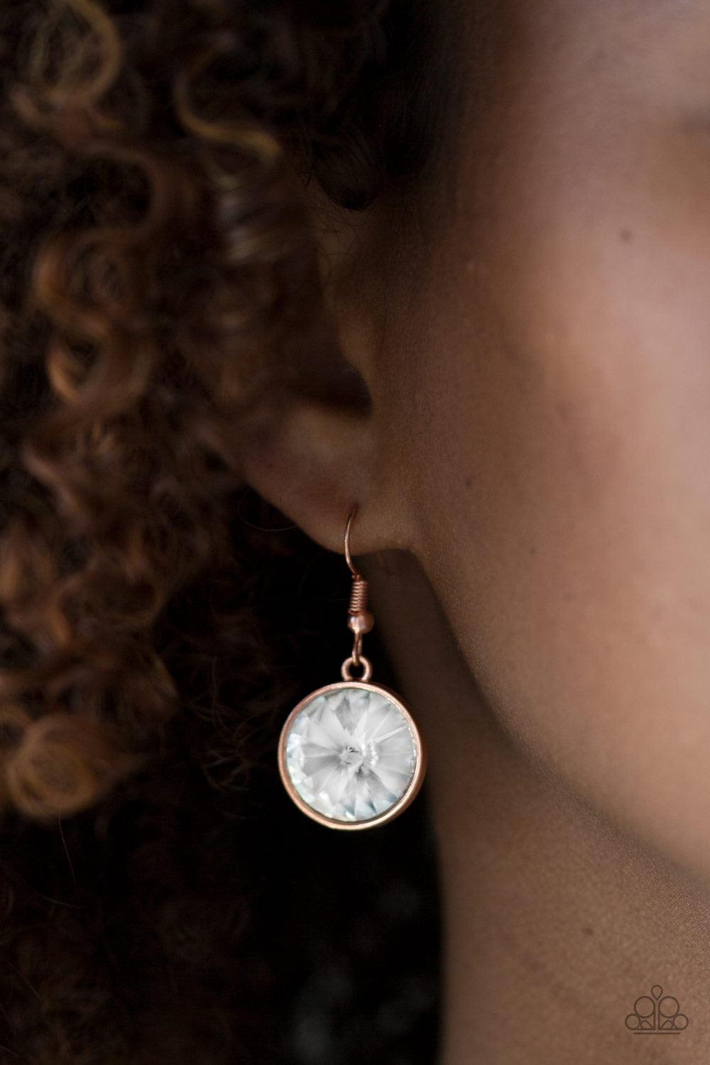 Paparazzi Accessories She Sparkles On - Copper A dramatic white gem swings from the bottom of a shiny copper chain, creating a blinding pendant below the collar. Features a toggle closure. Jewelry