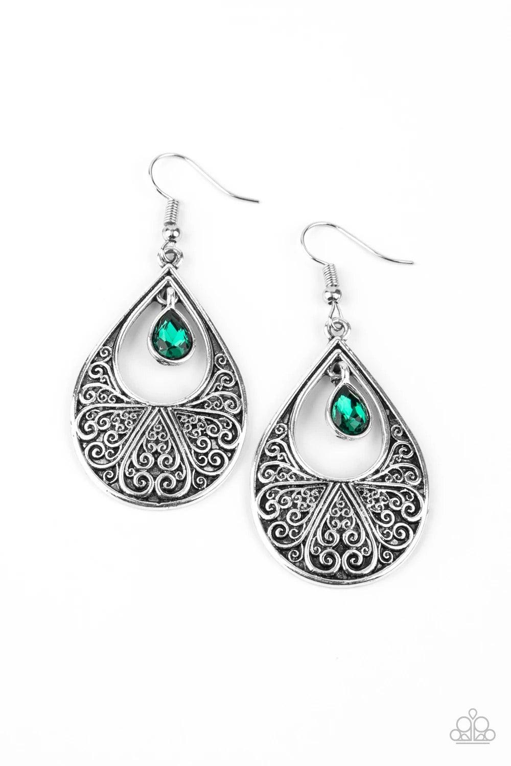 Paparazzi Accessories Garden Magic - Green A glassy green rhinestone swings from the top of an airy silver teardrop frame embossed with heart-shaped filigree, creating a whimsical lure. Earring attaches to a standard fishhook fitting. Sold as one pair of
