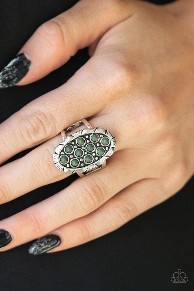 Paparazzi Accessories Cactus Garden - Green Dainty green stones are sprinkled across the front of a studded silver frame, creating a refreshing centerpiece atop the finger. Features a stretchy band for a flexible fit. Jewelry