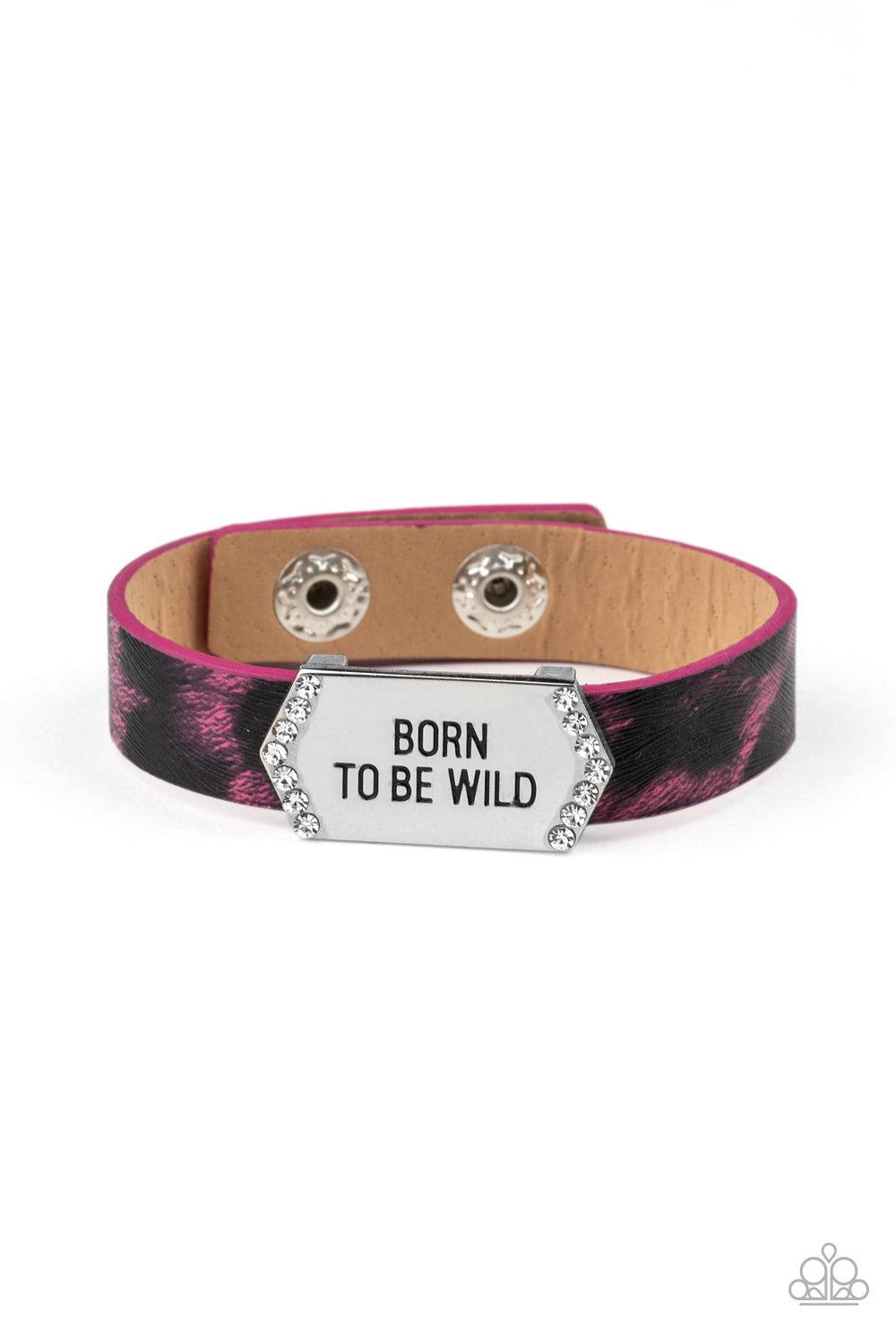 Paparazzi Accessories Born To Be Wild - Pink A white rhinestone encrusted silver frame stamped in the free-spirited phrase, "Born To Be Wild", slide along a shiny pink cheetah print leather band for a wild look. Features an adjustable snap closure. Jewelr