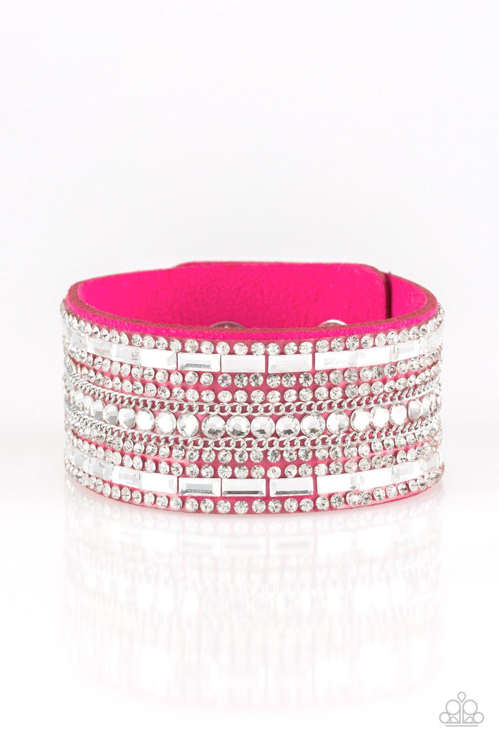 Paparazzi Accessories Rebel Radiance - Pink Featuring classic round and edgy emerald style cuts, glittery white rhinestones and glistening silver chains are encrusted along bands of pink suede for a sassy look. Features an adjustable snap closure. Sold as