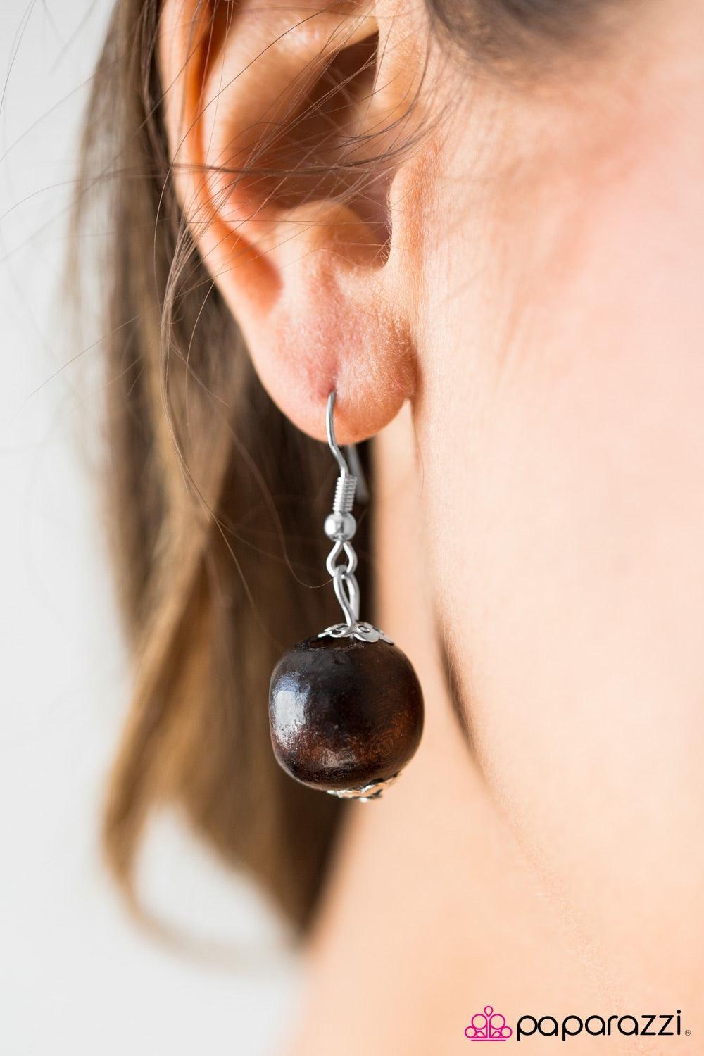 Paparazzi Accessories Honolulu Hula - Pink Shiny wooden beads trickle along a brown thread, creating an earthy chain. Tinted in a vibrant pink finish, a wooden floral accent gives way to dramatic layers of wooden beads and wooden discs for a summery finis