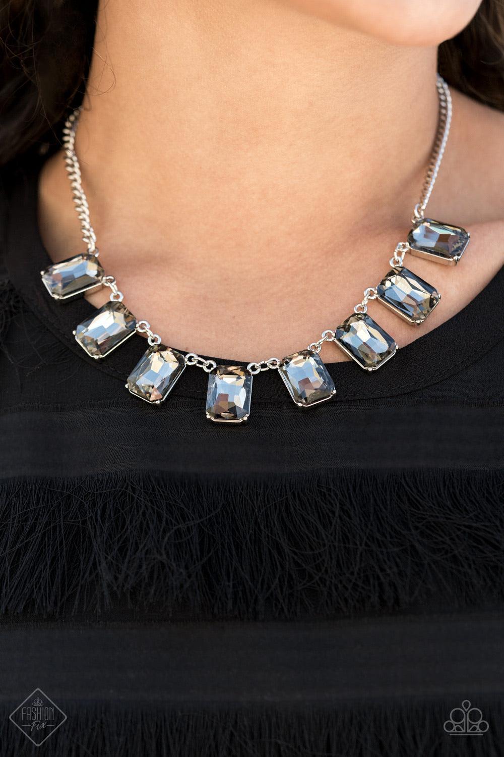 Paparazzi Accessories After Party Access - Silver Encased in sleek silver fittings, a regal chain of oversized smoky emerald-cut gems fans out below the collar in a dramatic finish. Features an adjustable clasp closure. Sold as one individual necklace. In