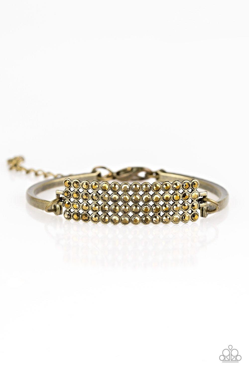 Paparazzi Accessories Top-Class Class - Brass Row after row of glittery aurum rhinestones stack into a gorgeous rectangular pendant. Attached to two arcing brass bars, the sparkling pendant sits atop the wrist for an undeniably glamorous look. Features an