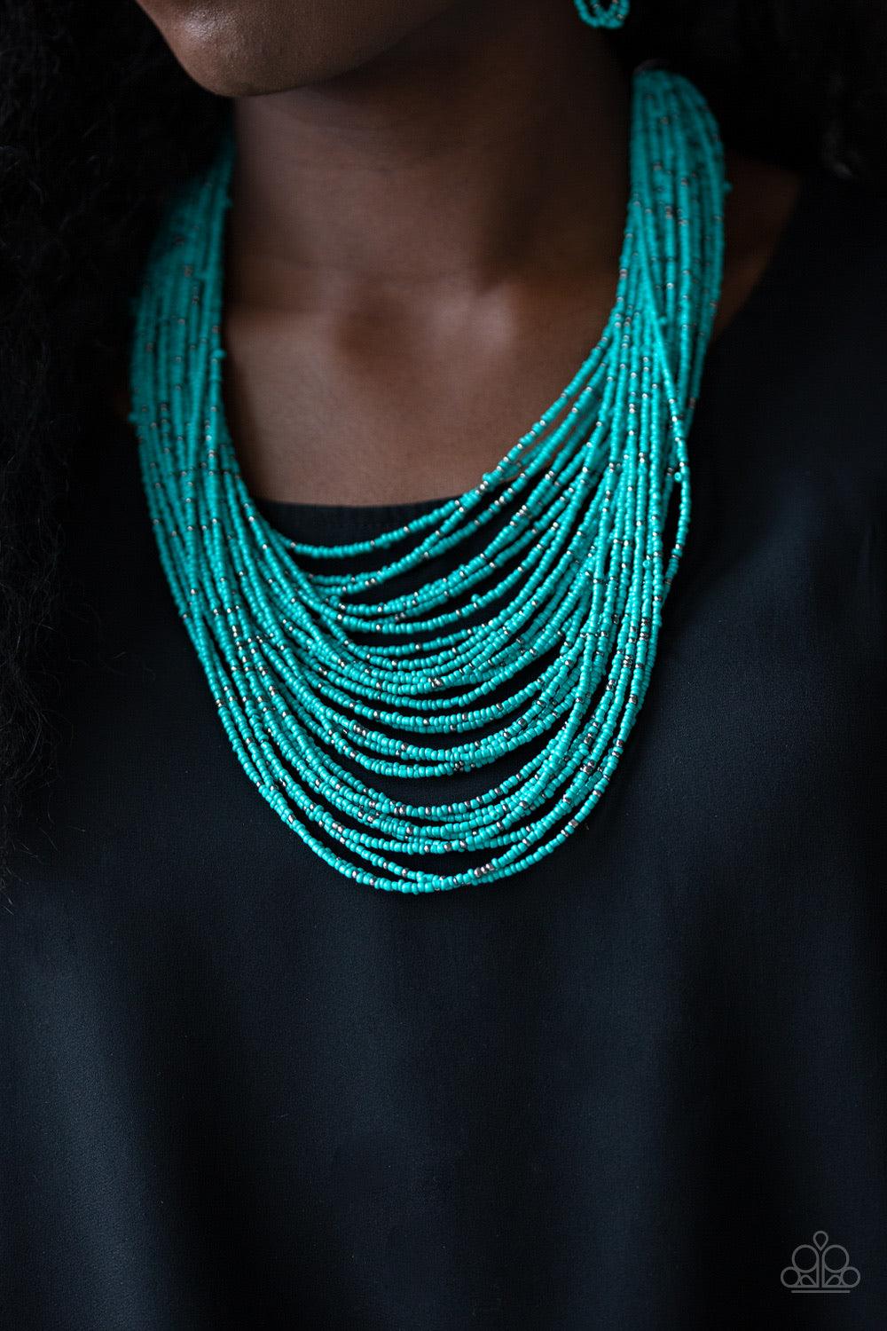 Paparazzi Accessories Rio Rainforest - Blue Suspended between two gunmetal fittings, row after row of countless strands of turquoise seed beads layer below the collar. Dainty gunmetal seed beads are sprinkled across the strands for a seasonal finish. Feat