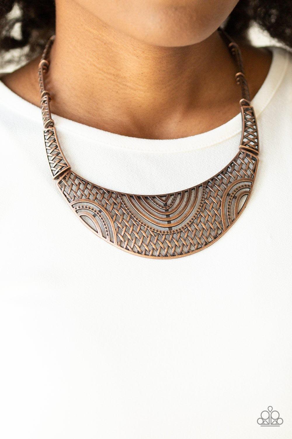 Paparazzi Accessories On The MANE Stage - Copper Featuring crisscrossed detail, dainty copper frames link below the collar, giving way to a dramatic half-moon plate radiating with airy tribal details for a fierce look. Features an adjustable clasp closure