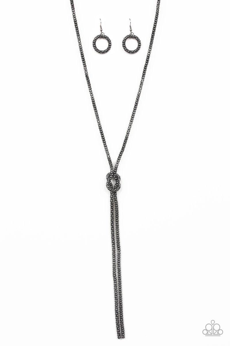 Paparazzi Accessories Born Ready - Black A glistening strand of lengthened gunmetal popcorn chain delicately knots at the chest, creating an edgy tasseled pendant. Features an adjustable clasp closure. Sold as one individual necklace. Includes one pair of