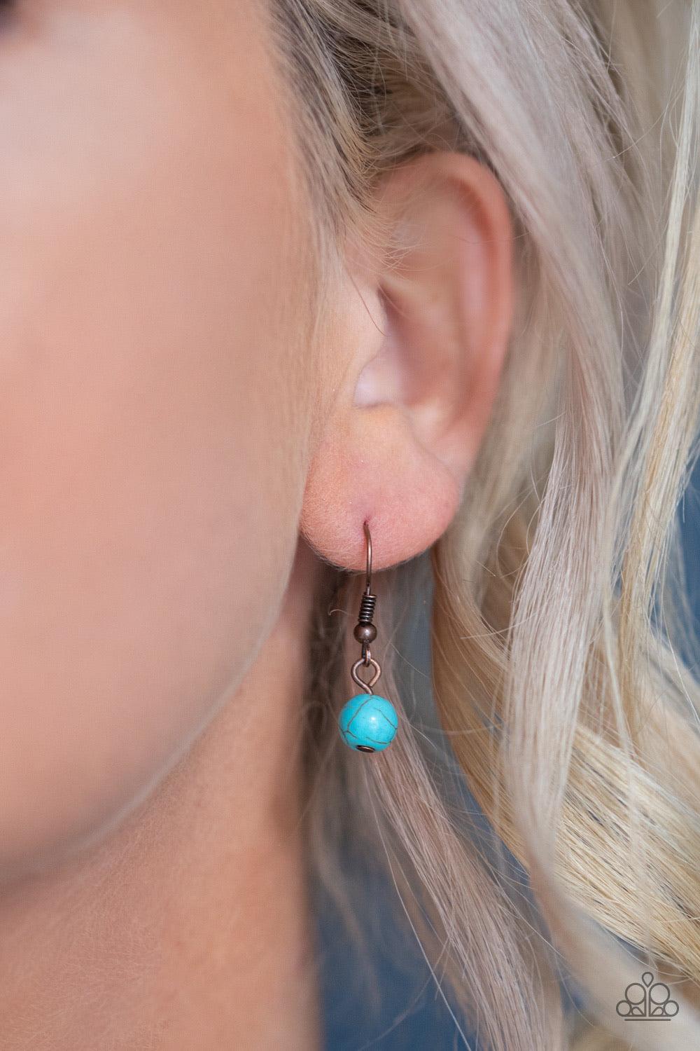 Paparazzi Accessories Desert Tranquility - Copper An earthy collection of dainty copper accents, rounded turquoise stone beads, and spotted ceramic-like beads are threaded along an invisible wire below the collar. An earthy wooden bead adorns the center,