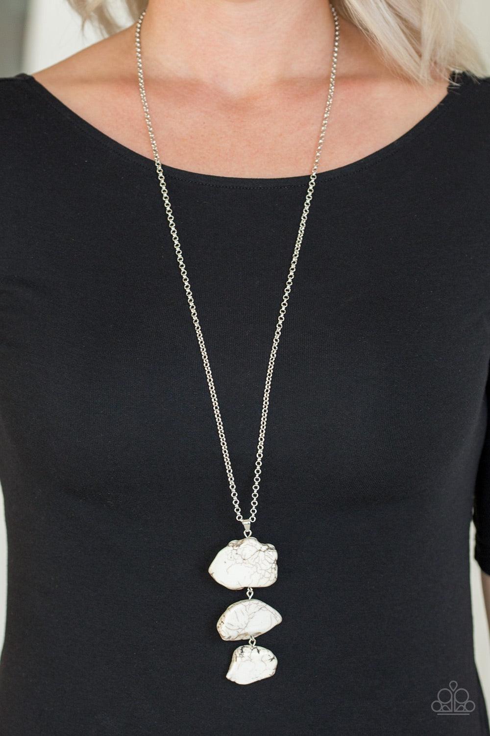 Paparazzi Accessories On The ROAM Again - White As if chipped off a cliff, pieces of white rock link at the bottom of a lengthened silver chain for an earthy look. As the stone elements in this piece are natural, some color variation is normal. Features a
