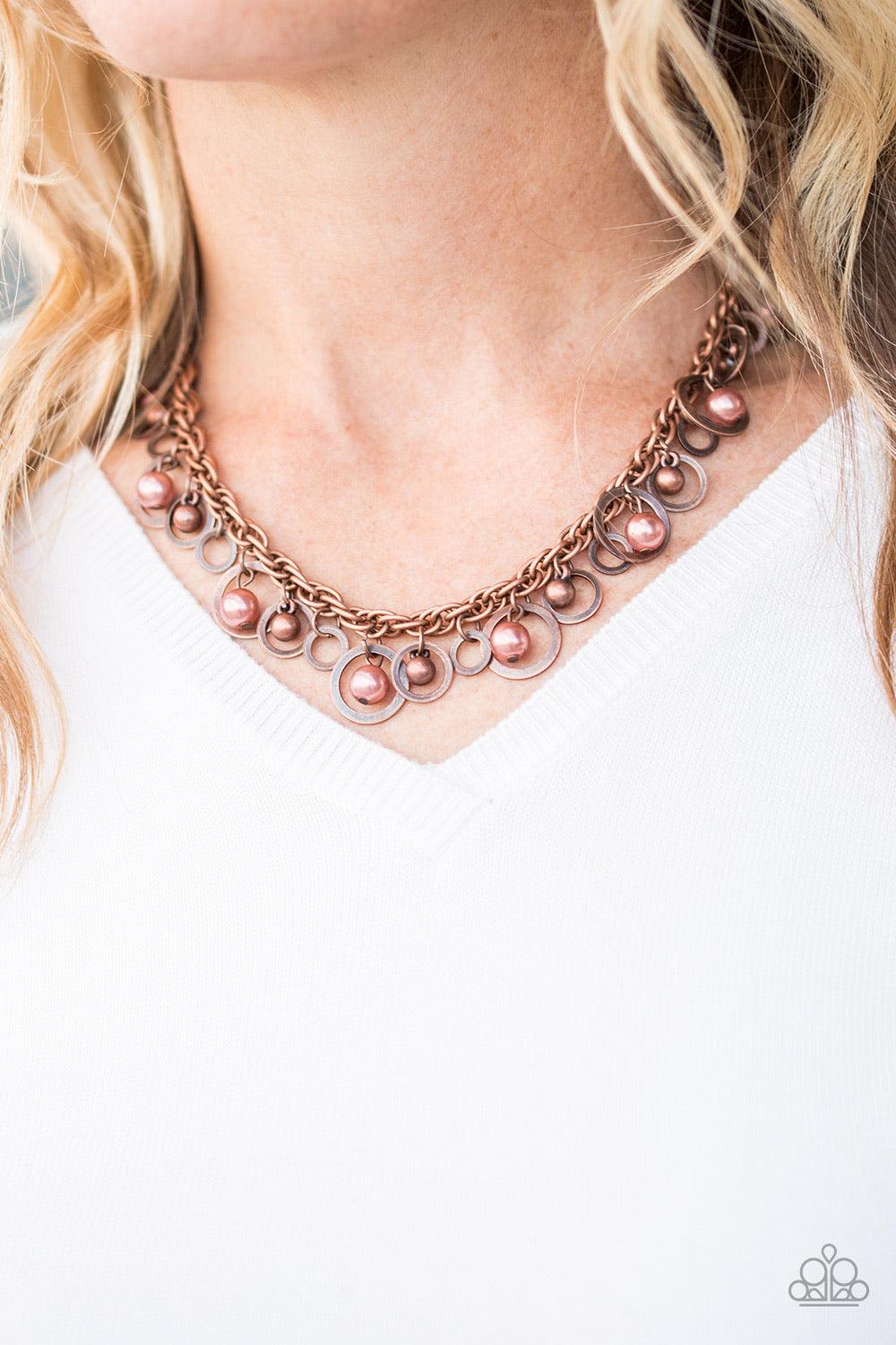 Paparazzi Accessories Shipwreck Style - Copper Brushed in an antiqued shimmer, mismatched copper hoops, copper pearls, and dainty copper beads swing from the bottom of a bold copper chain below the collar for a refined look. Features an adjustable clasp c