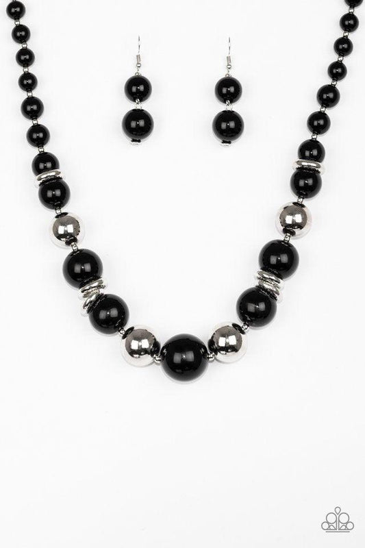Paparazzi Accessories New York Nightlife - Black Gradually increasing in size toward the center, dramatic black beads and shiny silver beads drape below the collar for a refined look. Glistening silver accents are sprinkled between the classic beads, addi