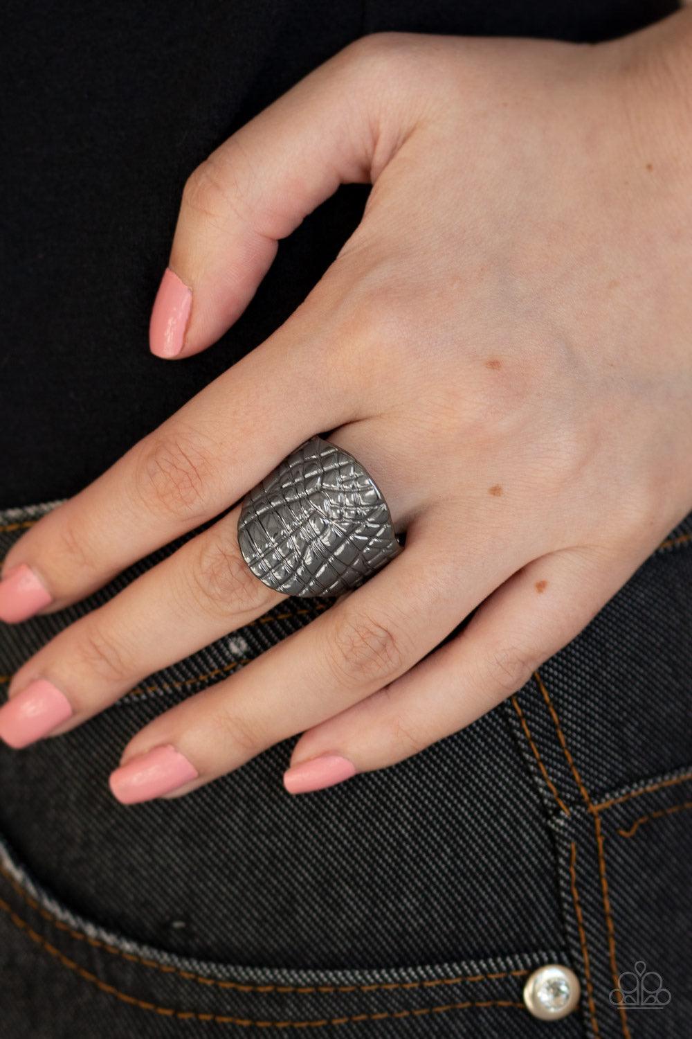 Paparazzi Accessories Metal Jungle - Black Etched in an abstract linear pattern, a thick gunmetal frame curls around the finger for an edgy metallic look. Features a stretchy band for a flexible fit. Jewelry