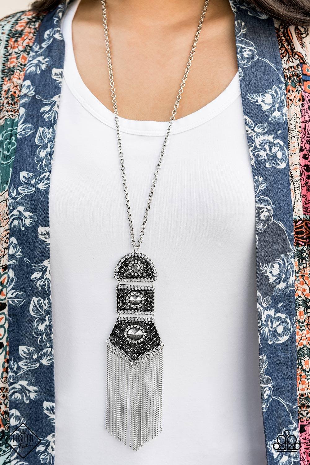 Paparazzi Accessories Tassel Tycoon - Silver Silver beads encircled by rhinestones are nestled inside a row of three vintage frames that cascade down the chest at the bottom of an elongated silver chain. Glistening silver chains stream from the bottom of