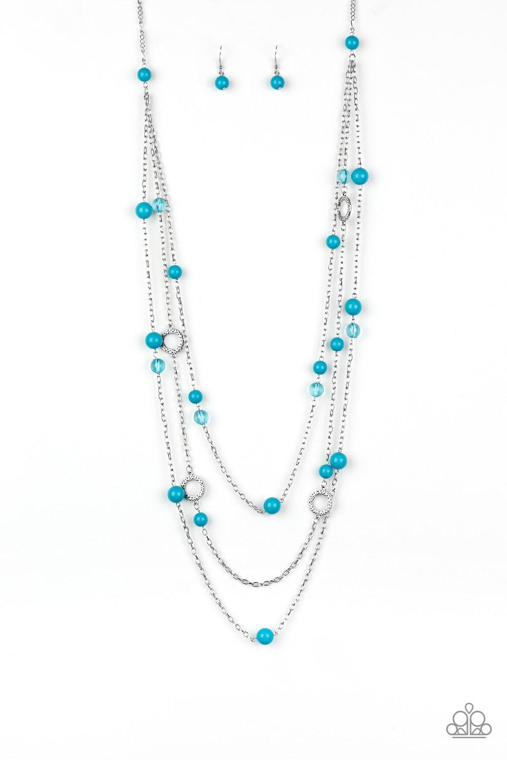 Paparazzi Accessories Brilliant Bliss - Blue A collection of glassy and polished blue beads trickle along rows of shimmery silver chains, creating colorful layers across the chest. Hammered silver hoops dot the bubbly layers, picking up and reflecting lig