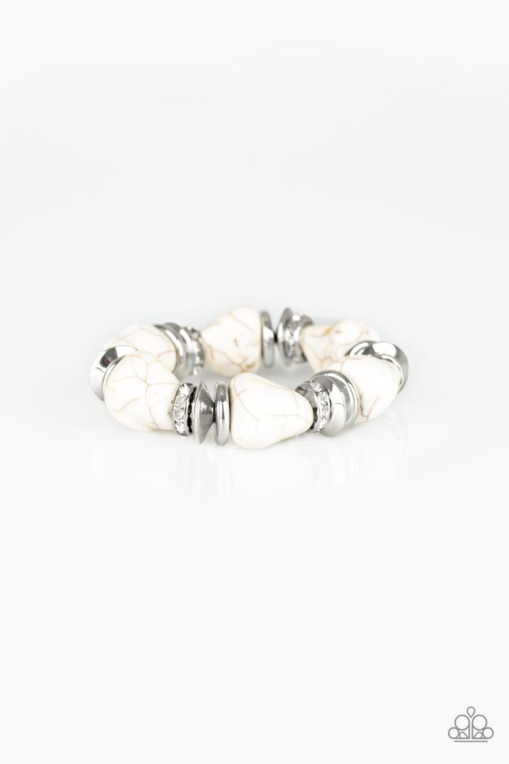 Paparazzi Accessories Stone Age Stunner - White A collection of refreshing white stones, shimmery silver accents, and white rhinestone encrusted rings are threaded along a stretchy band around the wrist for a seasonal look. Sold as one individual bracelet