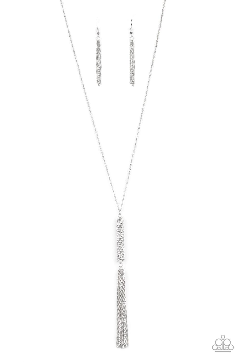 Paparazzi Accessories Towering Twinkle - White As if rolled in glitter, a chain of glassy white rhinestones spins tightly into a rounded silver pendant that swings from the bottom of a lengthened silver chain. A shimmery silver tassel dangles from the bot