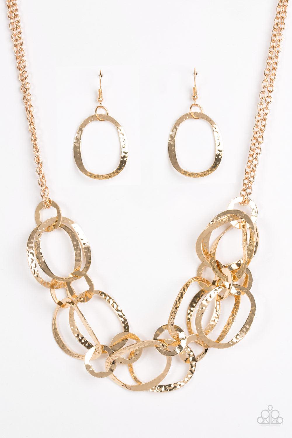 Paparazzi Accessories Circus Chic - Gold Featuring hexagonal centers, dainty gold rings link together two rows of hammered gold frames. The layered rows drape just below the collar for a refined look. Features an adjustable clasp closure. Sold as one indi