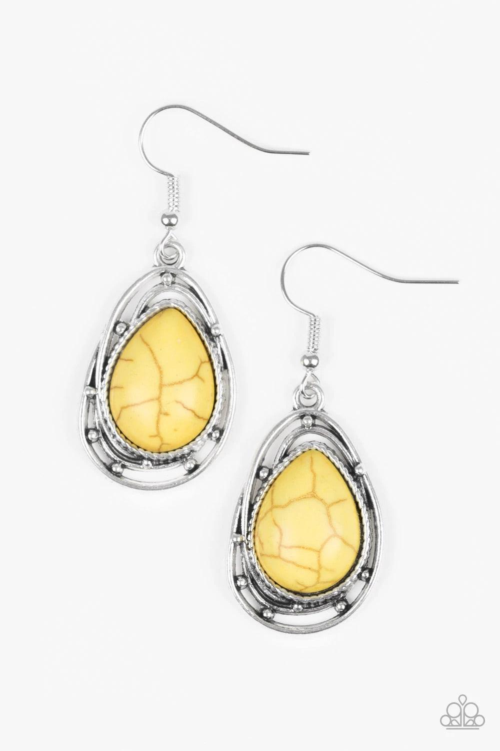 Paparazzi Accessories Abstract Anthropology - Yellow Chiseled into a tranquil teardrop, a sunny yellow stone is pressed into the center of a twisting silver frame for a handcrafted look. Earring attaches to a standard fishhook fitting. Sold as one pair of