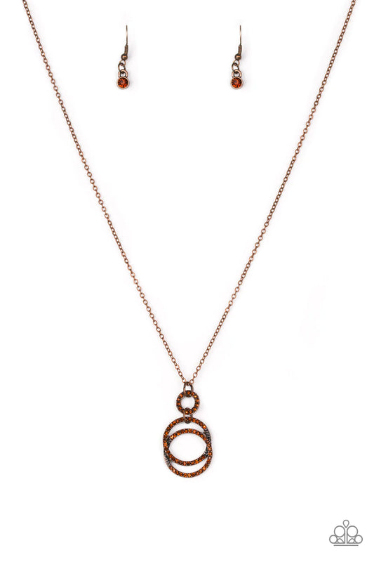 Paparazzi Accessories Timeless Trio - Copper Encrusted in radiant rhinestones, three copper hoops interlock at the bottom of an elongated copper chain for an elegant look. Features an adjustable clasp closure. Sold as one individual necklace. Includes one