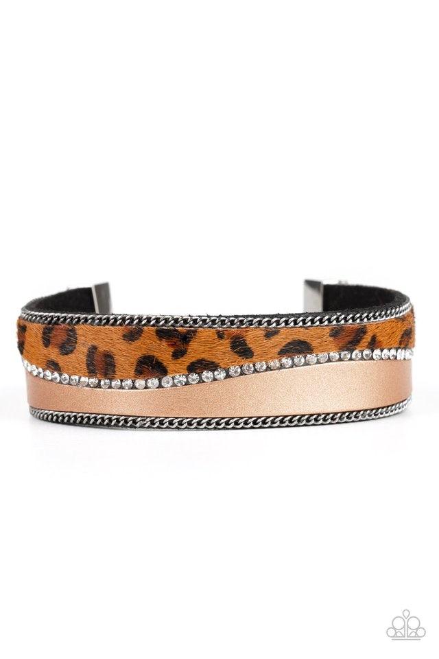 Paparazzi Accessories Flirtatiously Feline - Brown Infused with strands of antiqued silver chains and glassy white rhinestones, wavy pieces of tan leather and cheetah print line the front of a black suede band for a fierce look. Features an adjustable cla