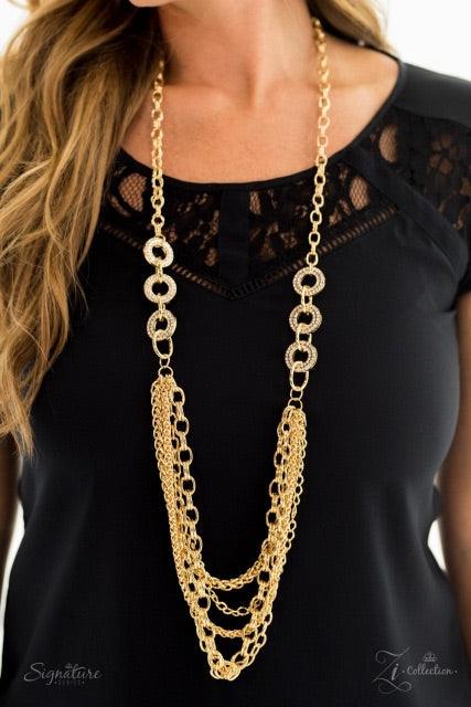 Paparazzi Accessories The Melissa Encrusted in glittery white rhinestones, glistening gold frames give way to layers of shimmery gold chains. Varying in size and shimmer, the bold assortment of gold chains drape across the chest in a fierce and flawless f